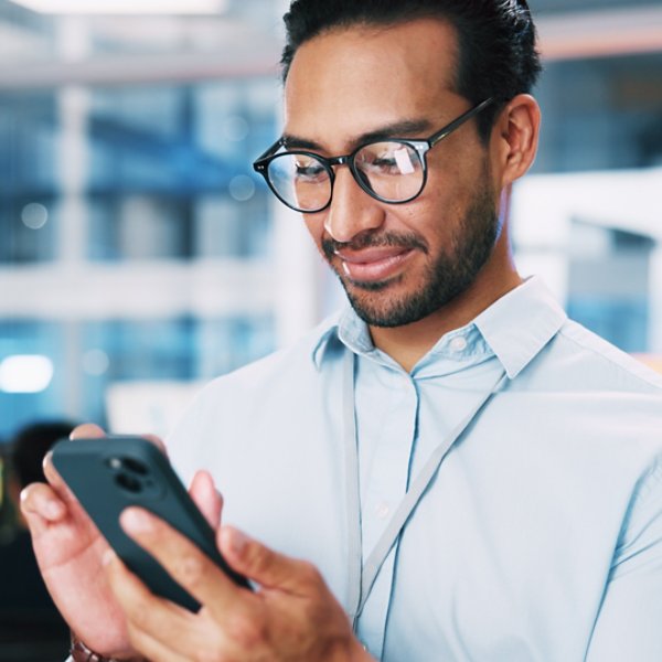 Business, coding and man in office, smartphone and software developer with digital app testing. Person, employee and professional in workplace, cellphone and programmer with AI expert and info tech.
