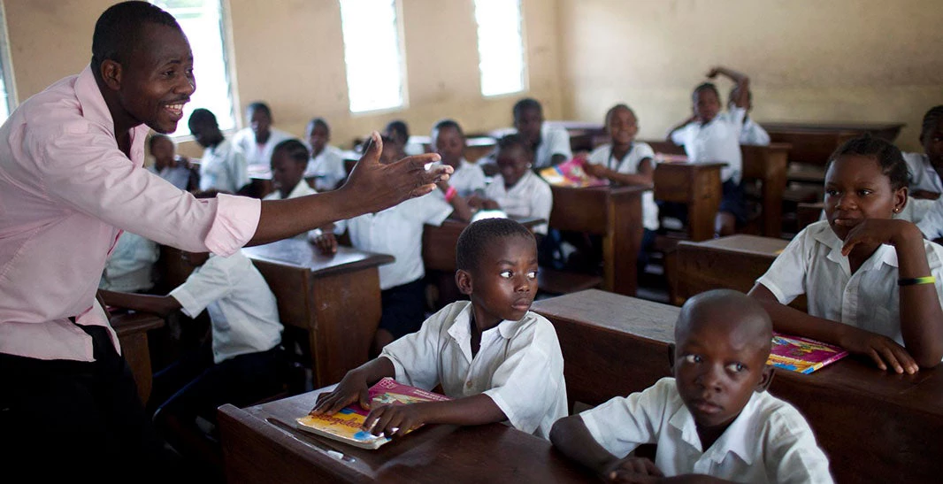 John Kazadi 4th grade teacher asking his students questions at the St. Louis Primary School in Kinshasa, DRC